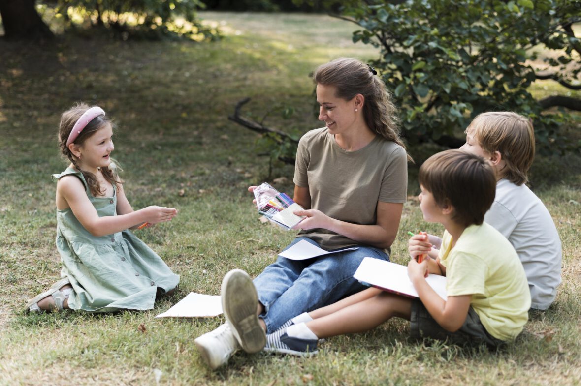 teacher-kids-sitting-grass